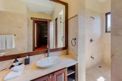 a bathroom with a sink and a large mirror at Pinilla Flor de Malinche 15 in Tamarindo