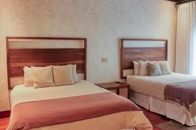 a hotel room with two beds in a room at Pinilla Flor de Malinche 15 in Tamarindo