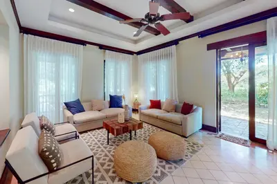 a living room with couches and a ceiling fan at Pinilla Flor de Malinche 15 in Tamarindo