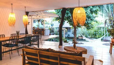 a restaurant with a table and chairs and a patio at Cuatro Vientos Lodge & Apartments - Santa Teresa, CR in Santa Teresa Beach