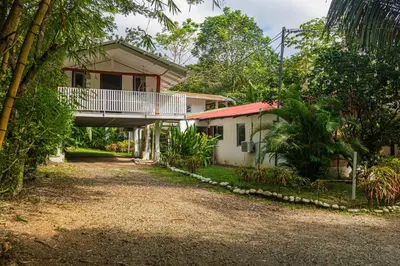a house with a balcony on the side of it at Cuatro Vientos Lodge & Apartments - Santa Teresa, CR in Santa Teresa Beach