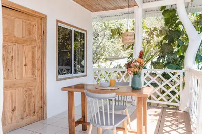 a dining room with a wooden table and chairs at Cuatro Vientos Lodge & Apartments - Santa Teresa, CR in Santa Teresa Beach