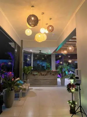 a lobby with potted plants and lights in a building at Hotel Naoz in Manuel Antonio