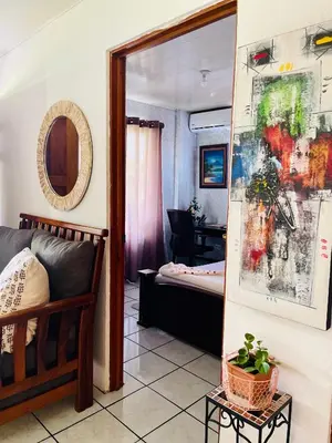a living room with a couch and a mirror at Sweet Home Carrión in Fortuna
