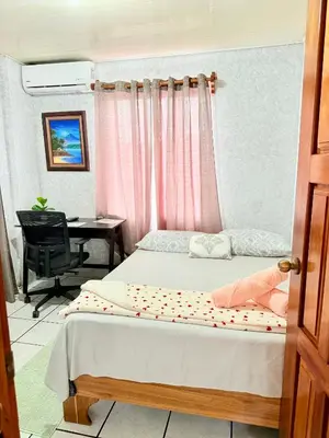 a bedroom with a bed and a desk with a computer at Sweet Home Carrión in Fortuna