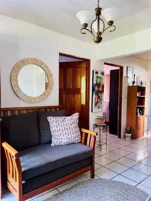 a living room with a couch and a mirror at Sweet Home Carrión in Fortuna