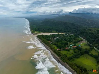 an aerial view of the shoreline of a beach at Bamboo River House and Hotel in Dominical