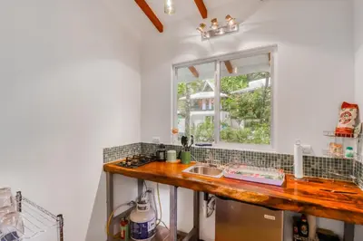 a kitchen with a sink and a window at Lost Pools Bungalow at Sloth in Uvita