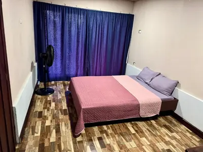 a bedroom with a bed and a purple curtain at La Cabaña de Merce in Tanque