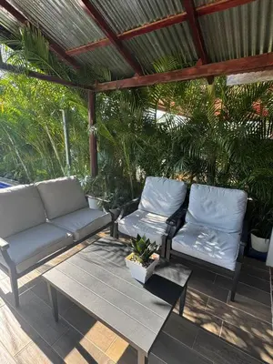 two couches and a table on a patio at La Cabaña de Merce in Tanque