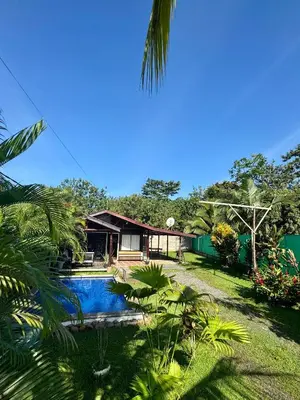 a house with a swimming pool in front of it at La Cabaña de Merce in Tanque