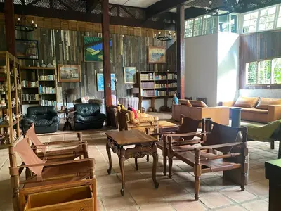 a room with chairs and tables in a library at Hotel Don Ernesto By La Chimba in San José