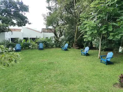 a group of blue chairs sitting in a yard at Hotel Don Ernesto By La Chimba in San José