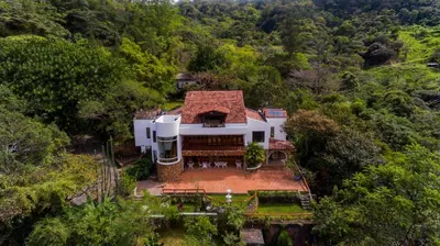 an aerial view of a house in the forest at Hotel Don Ernesto By La Chimba in San José
