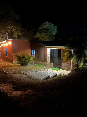 a house at night with a lit up at Cabaña Rana Verde in Monteverde Costa Rica