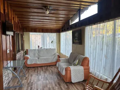a living room with two couches and a table at Cabaña Rana Verde in Monteverde Costa Rica