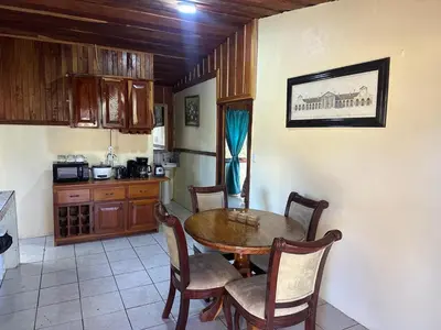 a kitchen with a table and chairs in a room at Cabaña Rana Verde in Monteverde Costa Rica