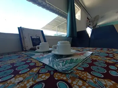 a table with cups and saucers on a train at The Dreamcatcher Bus in Sarchí
