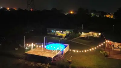 an overhead view of a swimming pool at night at The Dreamcatcher Bus in Sarchí