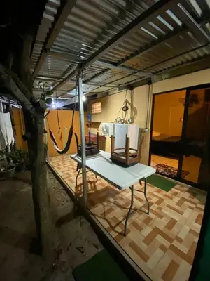a living area with a table and a room at La Casa de Cachi in Paquera