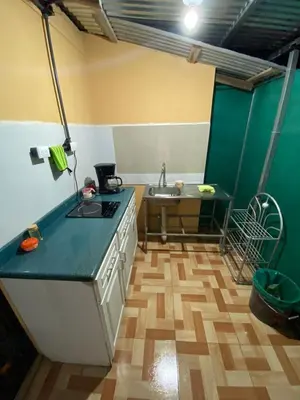 a kitchen with a sink and a counter top at La Casa de Cachi in Paquera