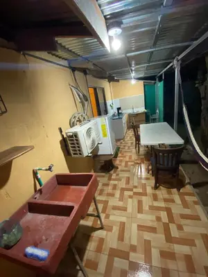 a room with a desk and a table and a tableablish at La Casa de Cachi in Paquera
