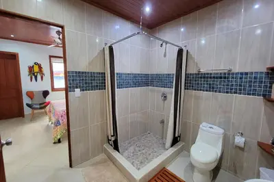 a bathroom with a shower and a toilet at LA BUENA VIDA CONDO in Tamarindo