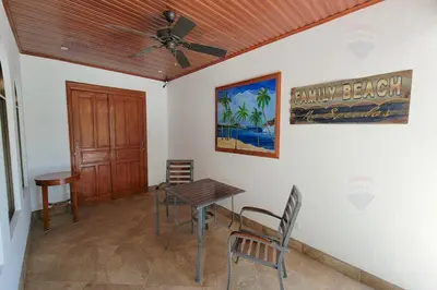 a dining room with a table and a ceiling fan at LA BUENA VIDA CONDO in Tamarindo