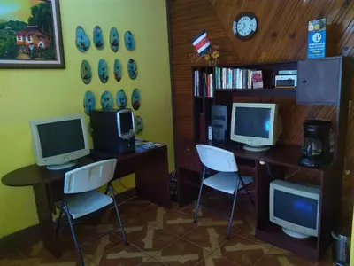 a room with two desks with computers and chairs at Hotel Marruecos C.R. in San José