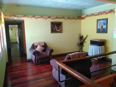 a living room with two chairs and a table at Hotel Marruecos C.R. in San José