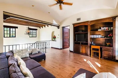 a living room with a couch and a tv at Villa Estrella del Mar in Tamarindo