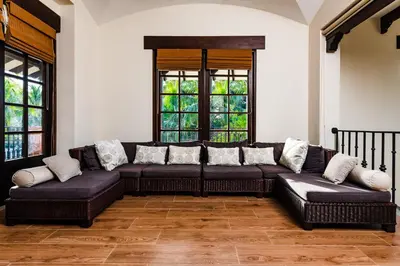 a living room with a couch and two windows at Villa Estrella del Mar in Tamarindo