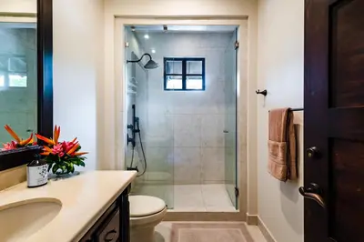 a bathroom with a shower with a toilet and a sink at Villa Estrella del Mar in Tamarindo