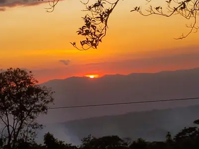 a sunset with the sun setting over the mountains at Ocean view in Monteverde Costa Rica