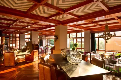 a dining room with a table and chairs at Alta Las Palomas Hotel in San José