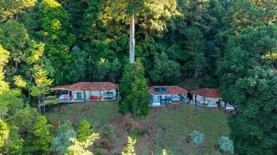an aerial view of a house in the woods at Dantica Cloud Forest Lodge in San Gerardo de Dota