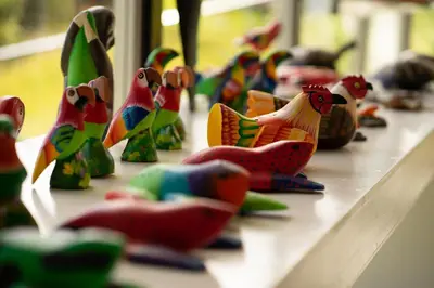 a group of toy birds sitting on a table at Dantica Cloud Forest Lodge in San Gerardo de Dota