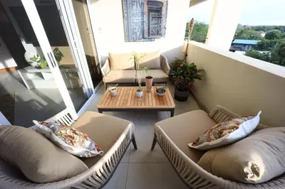 a balcony with two chairs and a coffee table at Brandnew Luxury 2Bdr condo✰Stunning view✰Fast wifi in Tamarindo