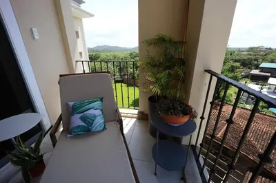 a balcony with a bench and plants on a balcony at Brandnew Luxury 2Bdr condo✰Stunning view✰Fast wifi in Tamarindo