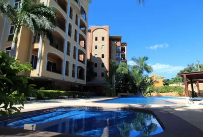 a swimming pool in front of a building at Brandnew Luxury 2Bdr condo✰Stunning view✰Fast wifi in Tamarindo