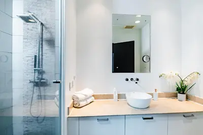 a bathroom with a sink and a shower at Sea La Vie Suites - By The Beach in Tamarindo