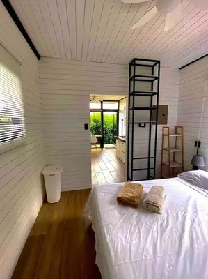 a bedroom with a bed with two towels on it at Hoja Azul Loft Guanacaste in Hojancha