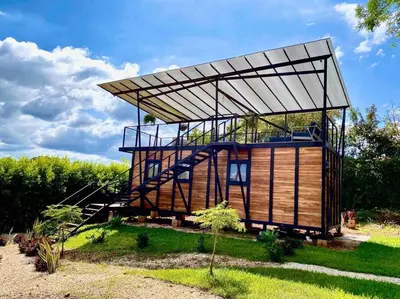 a house with a metal roof on top of it at Hoja Azul Loft Guanacaste in Hojancha