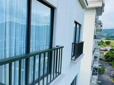 a balcony with windows and a view of a street at Stunning 9th Flr Pacific Ocean and Mtn View in Jacó
