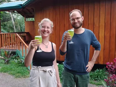 a man and woman holding glasses of green drinks at Casitas del Bosque Monteverde. in Monteverde Costa Rica