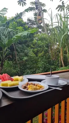a table with two plates of food and a cup of coffee at Casitas del Bosque Monteverde. in Monteverde Costa Rica