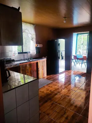 a kitchen with a wooden floor and a counter top at Amphibia House in Agua Azul