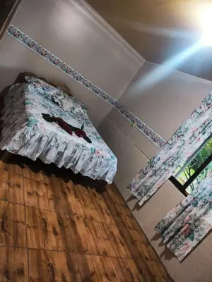 a room with a bed and a wooden floor at Amphibia House in Agua Azul