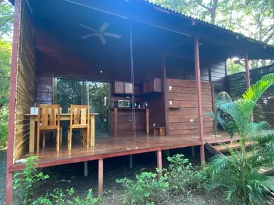 a house with a wooden deck with a table and chairs at Casa Natural Madera in Brasilito