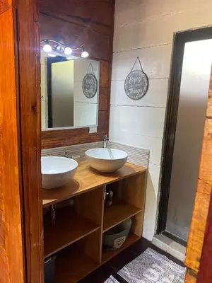 a bathroom with two sinks and a mirror at Casa Natural Madera in Brasilito